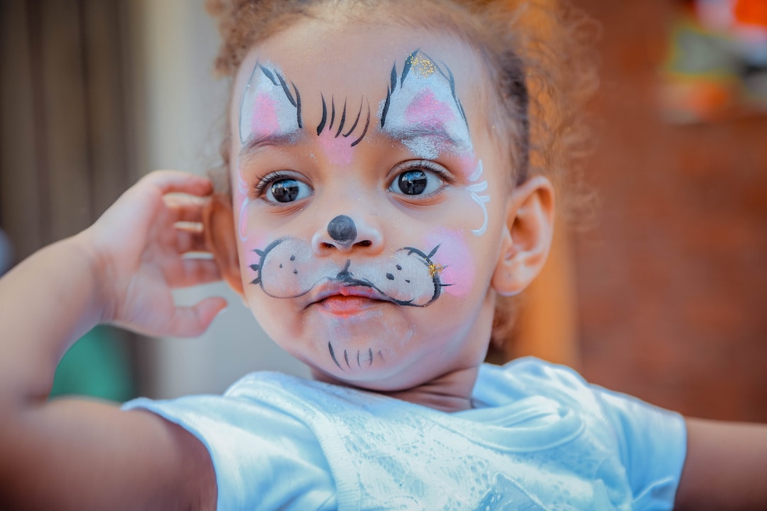 A young girl enjoying the face-painting services we offer at Clowns4Kids.