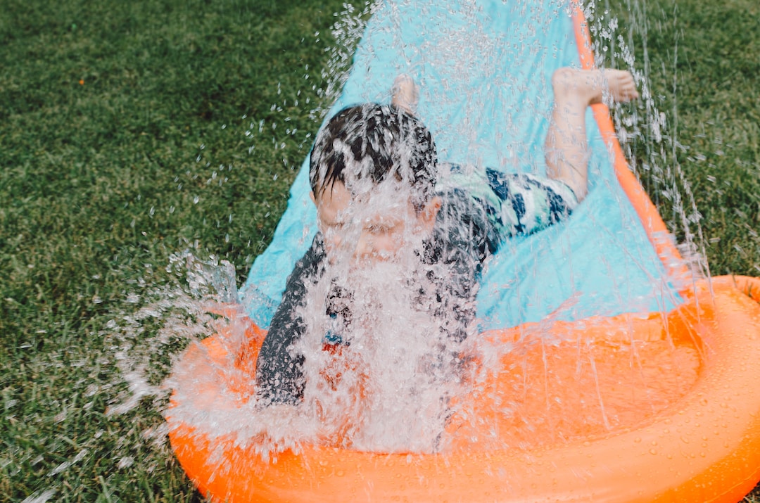 A child having fun on a slip-and-slide style water slide