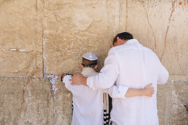 A boy and his father prepare for a bar mitzvah, an important rite of passage for any young Jewish boy.