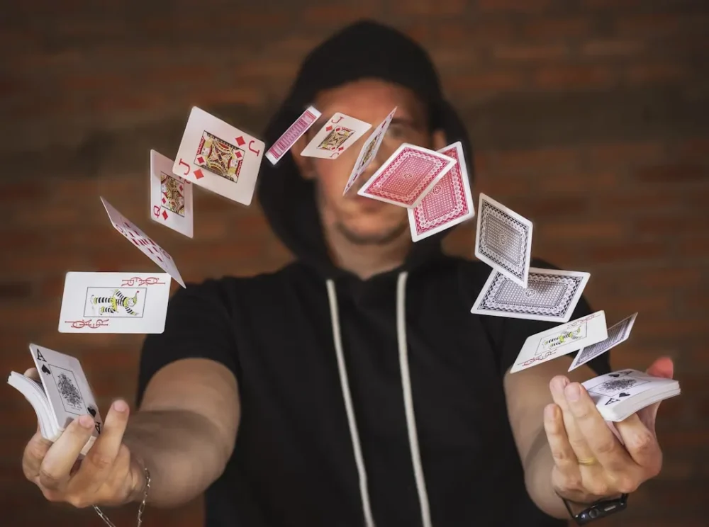 Magician playing with cards as one of many party rentals and performers