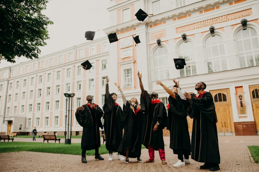 College graduates throwing their graduation caps into the air to celebrate the occasion