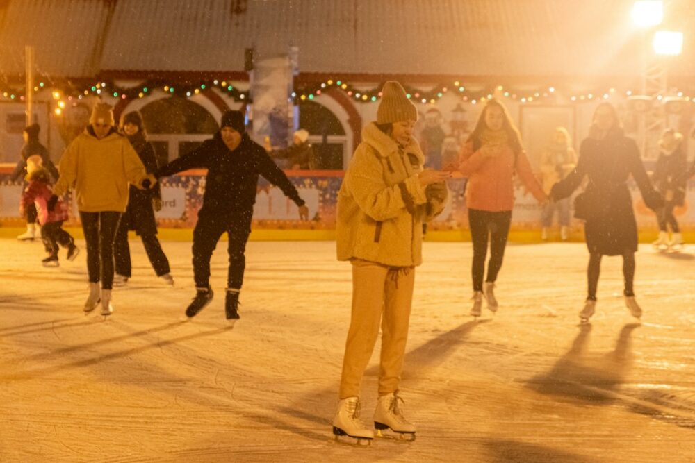 Loved ones gathering on a portable ice rink for a Christmas celebration